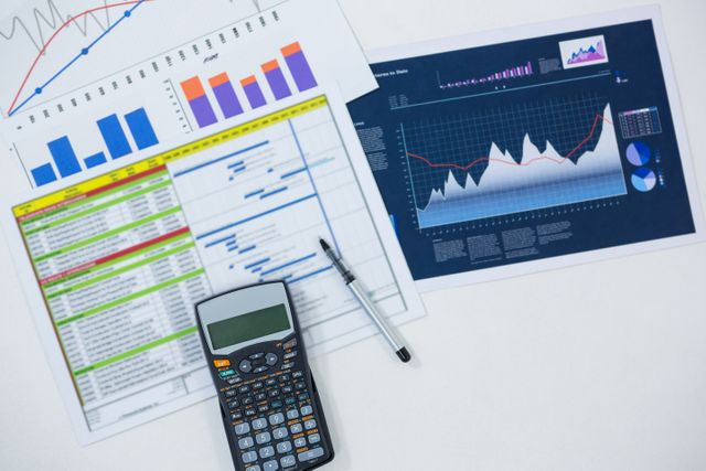 Financial Analysis with Graphs and Calculator on White Background - Download Free Stock Photos Pikwizard.com