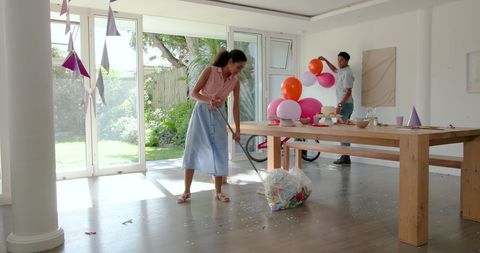 Couple decorating living room for party celebration