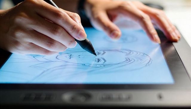 Artist sketching female portrait with stylus on backlit tablet digital illustration workstation
