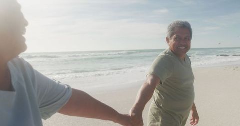 Loving Senior Couple Holding Hands on Serene Beach Walk - Download Free Stock Images Pikwizard.com