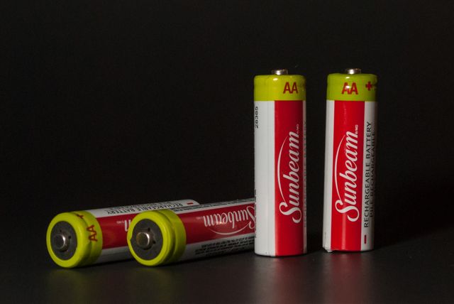 Four AA Batteries on Dark Background - Download Free Stock Images Pikwizard.com