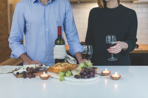 Couple Enjoying Wine and Bread in Modern Kitchen