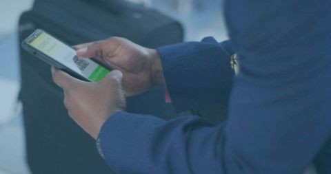 Business Traveler Verifying QR Code at Airport Gate