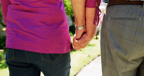 Senior Couple Holding Hands in Nursing Home Garden