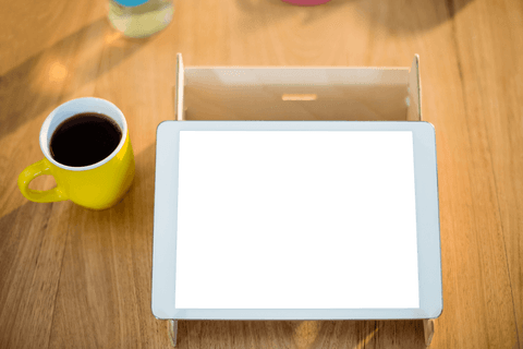 Transparent Tablet on Wooden Table with Yellow Mug