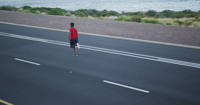 Man Jogging on Seaside Road for Morning Exercise - Download Free Stock Images Pikwizard.com