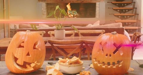 Carving Pumpkins on Rustic Dining Table with Fireplace Glow and Autumn Ambience