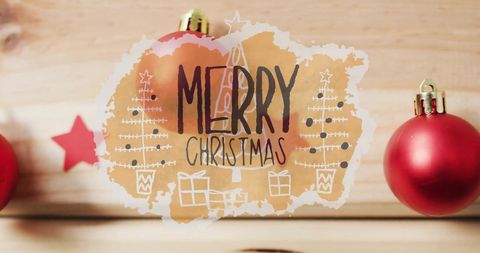 Merry Christmas Text with Festive Ornaments and Wooden Background