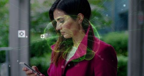 Woman at bus stop exploring digital connectivity through smartphone