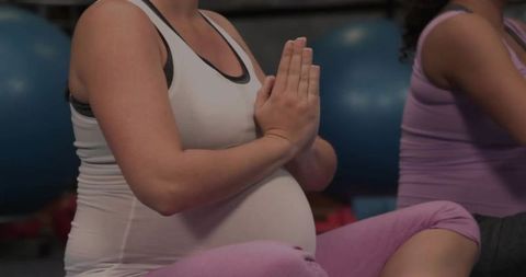 Pregnant Woman Practicing Yoga in Studio for Mindfulness
