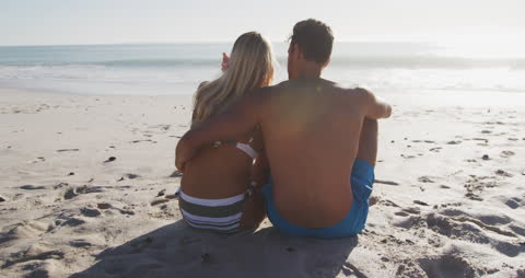 Couple Embracing at Beach with Ocean Views on Sunny Day