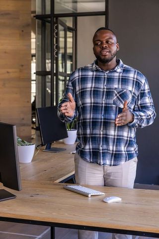 Professional Man Presenting in Modern Office Environment