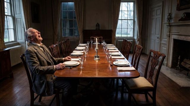 Laughing Elderly Gentleman at Long Antique Dining Table in Grand Historic Dining Room
