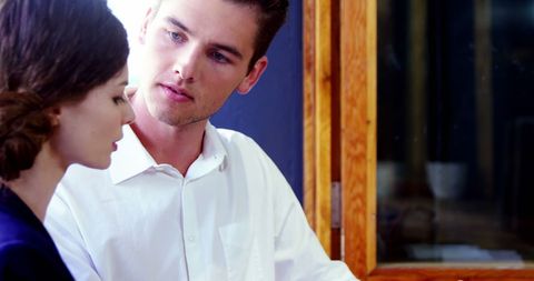 Focused Couple Enjoying Moment Together in Cafe