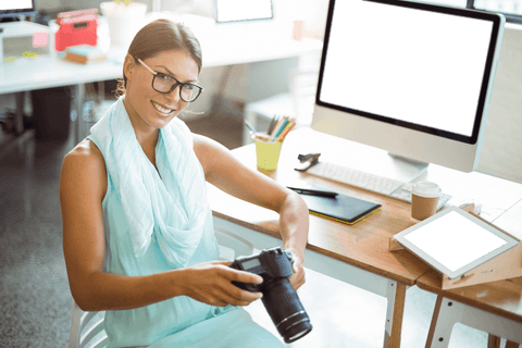 transparent smiling designer holding camera with office background - Download Free Stock Videos Pikwizard.com