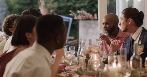 Elegant Outdoor Wedding Dinner with Guests Sharing Lively Conversation