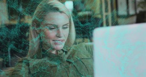 Blonde Woman Engaging with Digital Data on Laptop