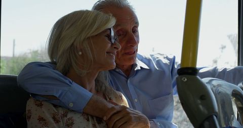 Smiling Senior Couple Enjoying Bus Ride Together