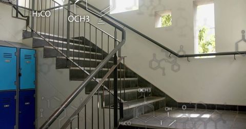 U-shaped tiled staircase in modern lab stairwell with blue lockers and chemical formula overlays