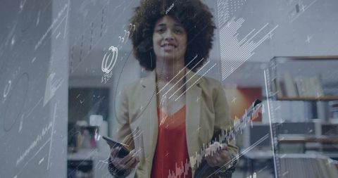 Business analyst analyzing data behind glass holding phone and tablet with interactive digital chart