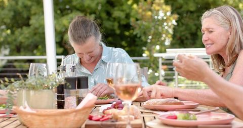 Smiling Women Enjoying Outdoor Meal Together - Download Free Stock Images Pikwizard.com