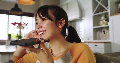 Young woman engaging in phone communication at cozy home