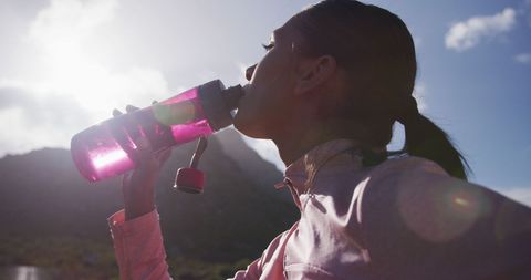 Woman Staying Hydrated on Mountain Hiking Journey - Download Free Stock Images Pikwizard.com
