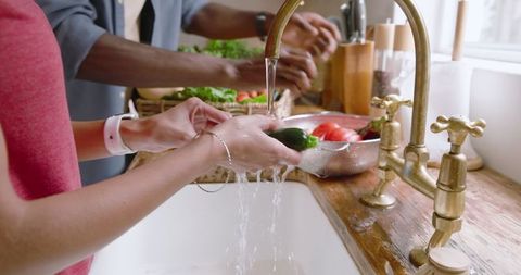 Rinsing Fresh Vegetables in a Farmhouse Kitchen Setting
