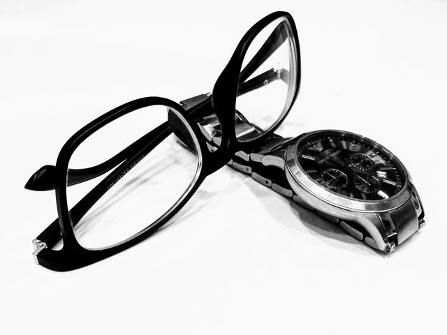 Close-Up of Eyeglasses and Watch on White Background - Download Free Stock Photos Pikwizard.com