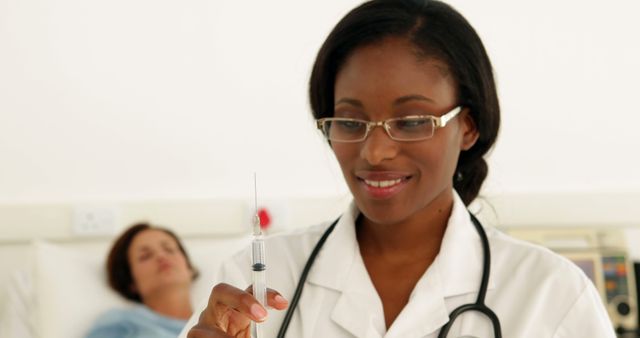 This image depicts a focused female nurse in a white uniform preparing an injection with a syringe. The background features a patient lying in a hospital bed. It is ideal for use in medical articles, healthcare promotions, hospital brochures, and educational materials about nursing and patient care.