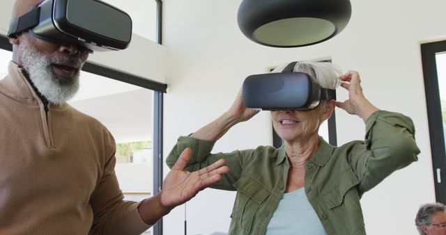 Happy senior diverse people using vr headsets at retirement home - Download Free Stock Photos Pikwizard.com