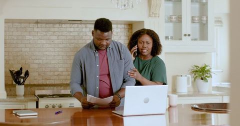Couple Managing Finances in Modern Kitchen