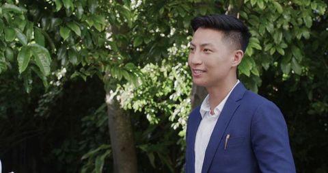 Groom in Blue Suit Smiling at Outdoor Wedding Ceremony