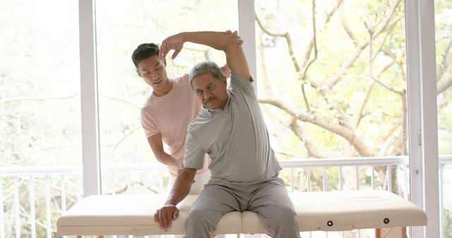 Therapist Assisting Elderly Man with Physical Therapy Stretches - Download Free Stock Images Pikwizard.com