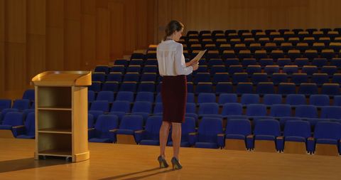 Businesswoman Rehearsing Speech in Empty Auditorium - Download Free Stock Images Pikwizard.com