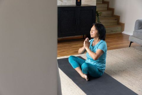 Senior Woman Meditating at Home Embracing Tranquility and Mindfulness
