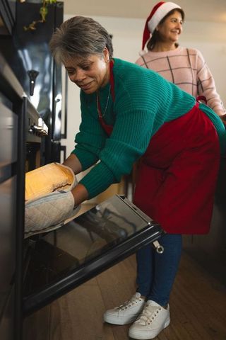 Senior woman baking bread at home for holiday celebration