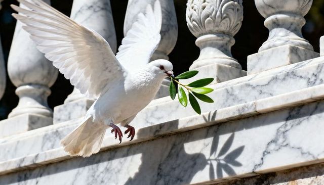 Sunlit white dove carrying olive branch over carved marble balustrade, symbol of peace