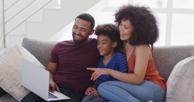 Happy Family Sitting on Couch Using Laptop Together - Download Free Stock Images Pikwizard.com