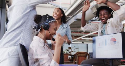 Diverse Team Celebrating Office Success with High Fives