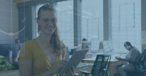 Smiling woman holding tablet in coworking office showing financial charts overlay