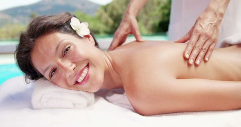 Smiling Woman Enjoying Relaxing Poolside Massage