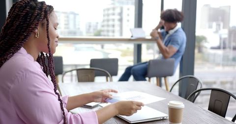 Professional Woman Reviewing Documents in Modern Office Environment