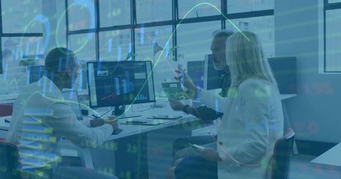 Coworkers Analyzing Data on Computers in Modern Office