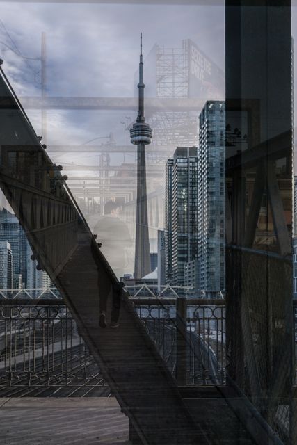 Skyline featuring CN Tower and urban structures with artistic reflections, perfect for travel, architecture, and modern urban themes in marketing materials and editorials. Useful for illustrating contemporary city life and iconic landmarks in Canada.