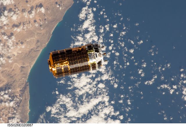 Japanese Kounotori2 H-II Transfer Vehicle approaching International Space Station backdropped by Earth. Useful for content related to space exploration, satellite technology, international space missions, and aerospace advancements.