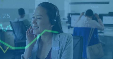 Businesswoman Collaborating in Open-Office Setting with Technology