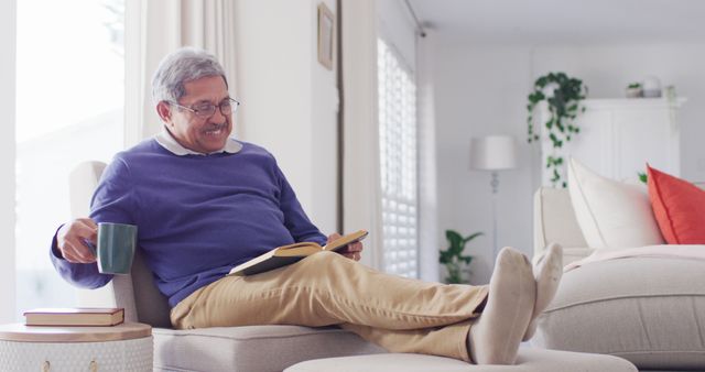 Senior Man Relaxing at Home Reading Book and Drinking Coffee - Download Free Stock Images Pikwizard.com