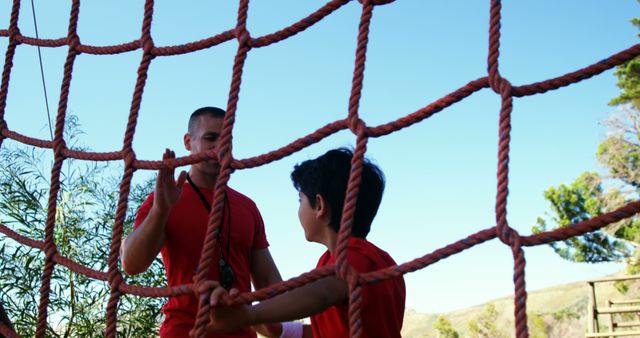 Coach Motivating Boy on Rope Climbing Course - Download Free Stock Images Pikwizard.com