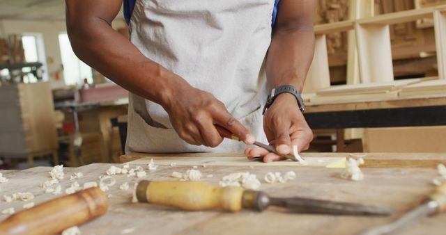 Person Carving Wood in Workshop Wearing White Apron - Download Free Stock Images Pikwizard.com